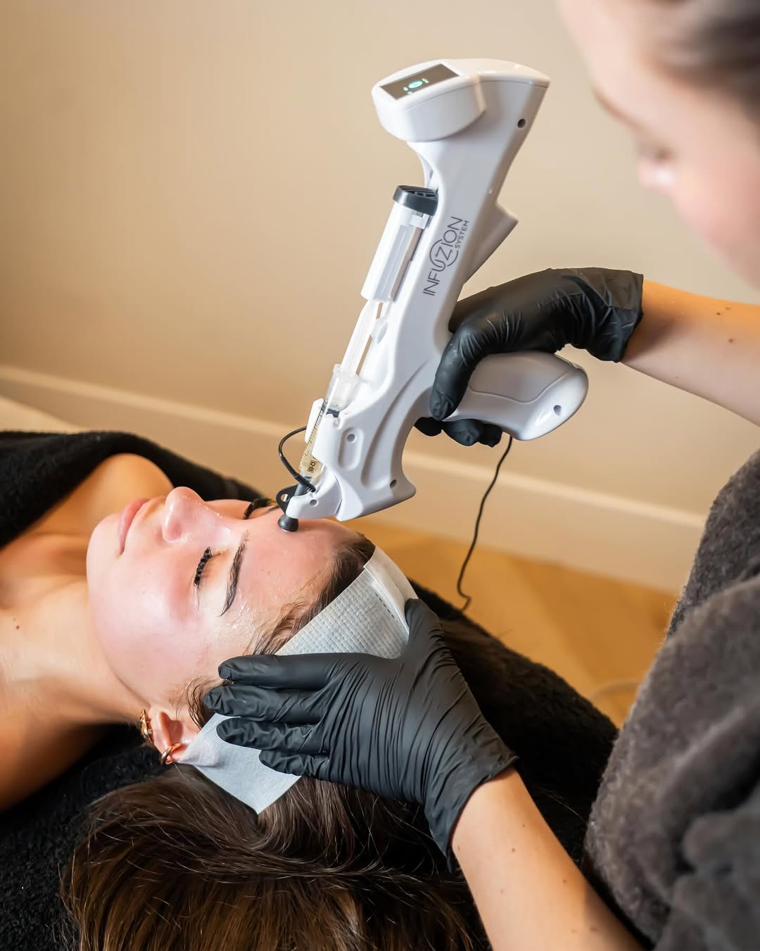 Schoonheidsspecialiste geeft een naaldvrije Infuzion System-behandeling in haar salon